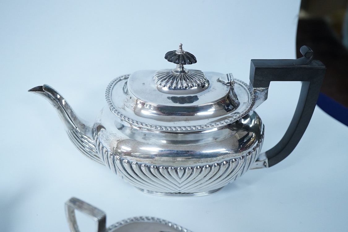 A late Victorian demi-fluted silver oval three piece bachelor's tea set, by James Deakin & Sons, Chester, 1893, gross weight 15.7oz.